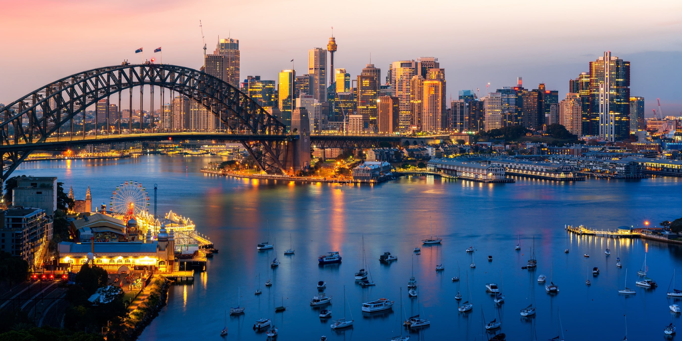 Sydney Harbour, the Harbour Bridge and city skyline at dusk